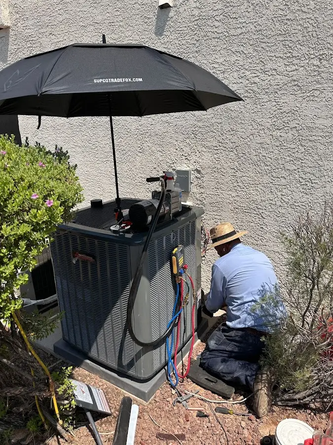 HVAC technician performing outdoor AC maintenance in Breckenridge